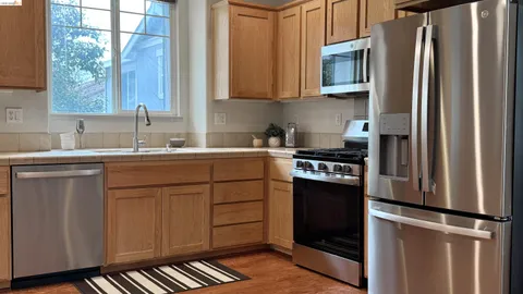 a kitchen with stainless steel appliances a refrigerator sink and cabinets
