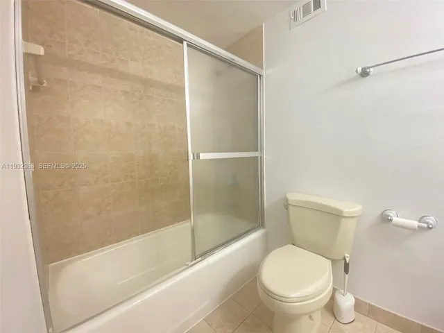 a bathroom with a shower and a toilet