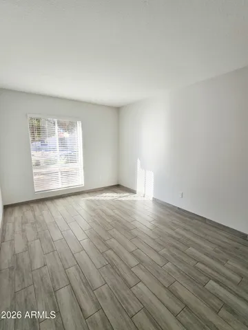 wooden floor in an empty room with a window