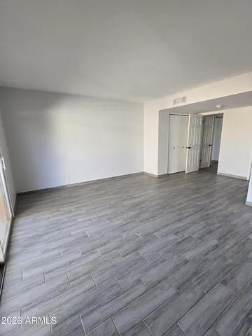 a view of an empty room and wooden floor