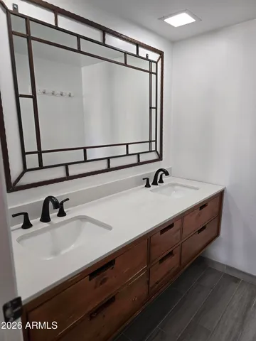 a bathroom with a sink and a mirror