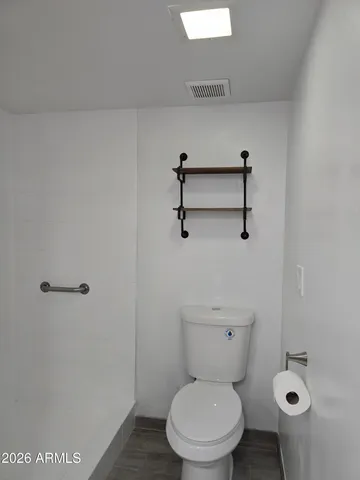a white toilet sitting next to a bathroom sink