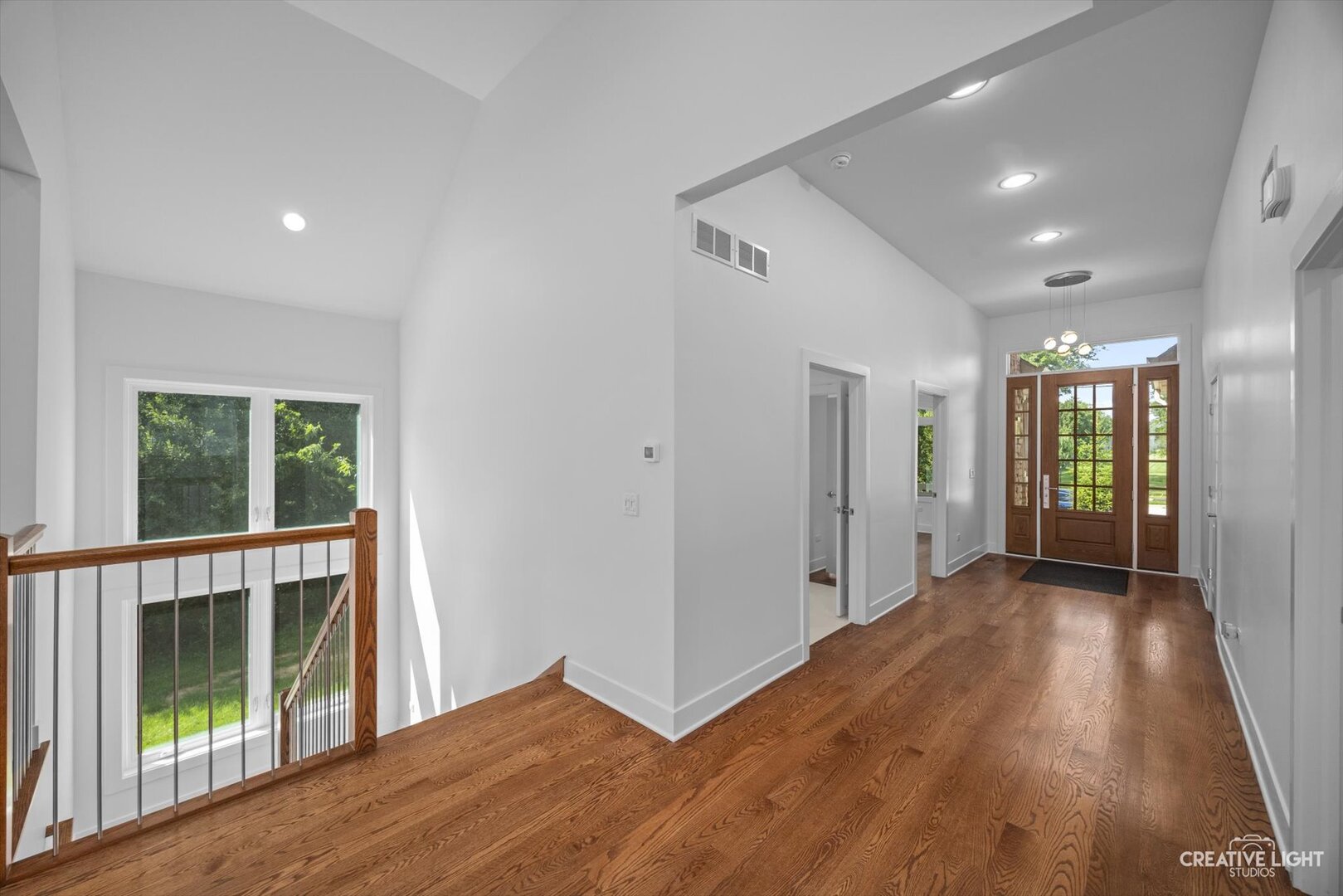 7625 Dunham Road Woodridge, IL 60517 - Photo 3 of 25 a view of hallway with a large window and wooden floor