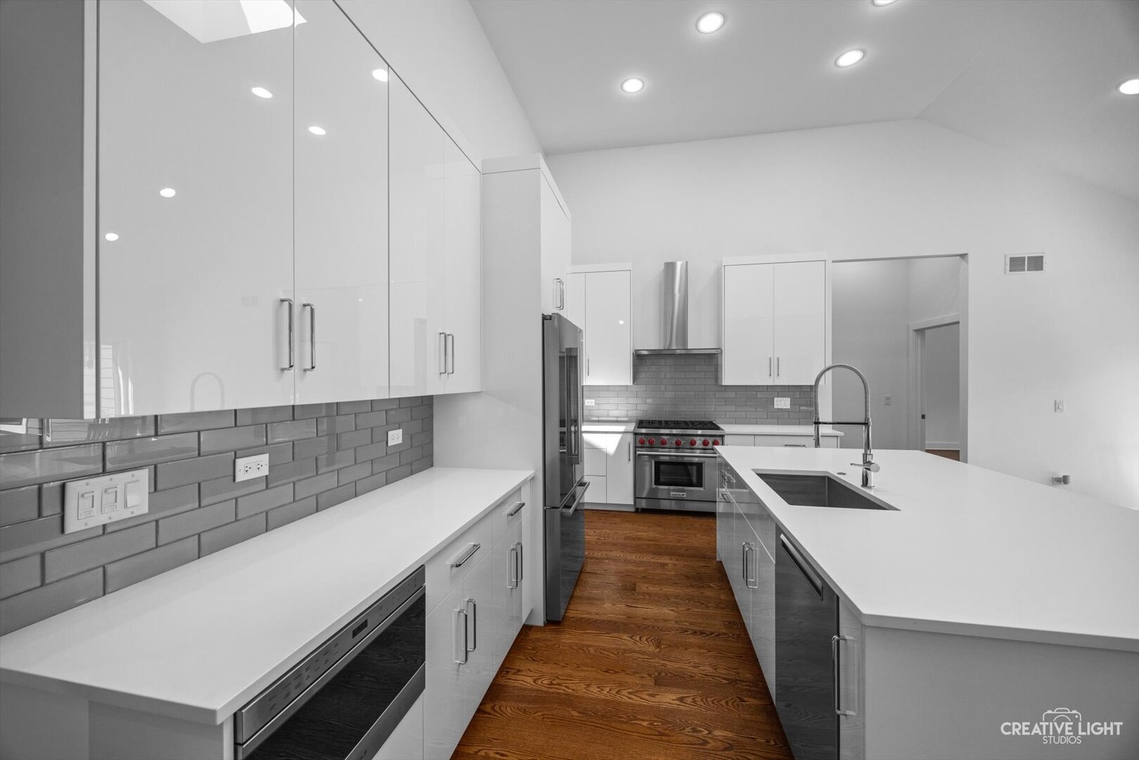 7625 Dunham Road Woodridge, IL 60517 - Photo 10 of 25 a large kitchen with kitchen island a sink stainless steel appliances and cabinets