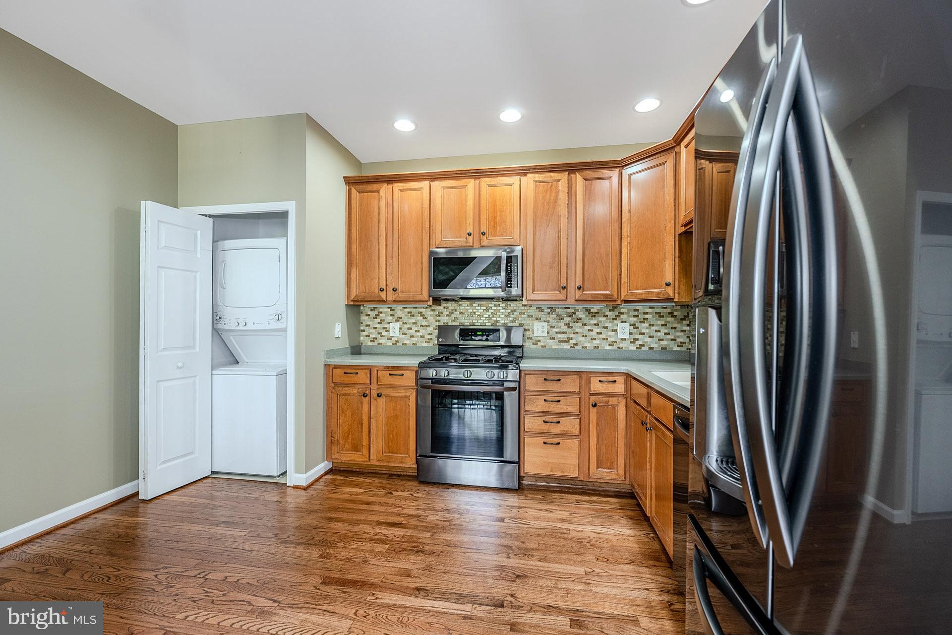 230 West Ridge Court Warrenton, VA 20186 - Photo 13 of 44 a kitchen with stainless steel appliances granite countertop a refrigerator stove and sink