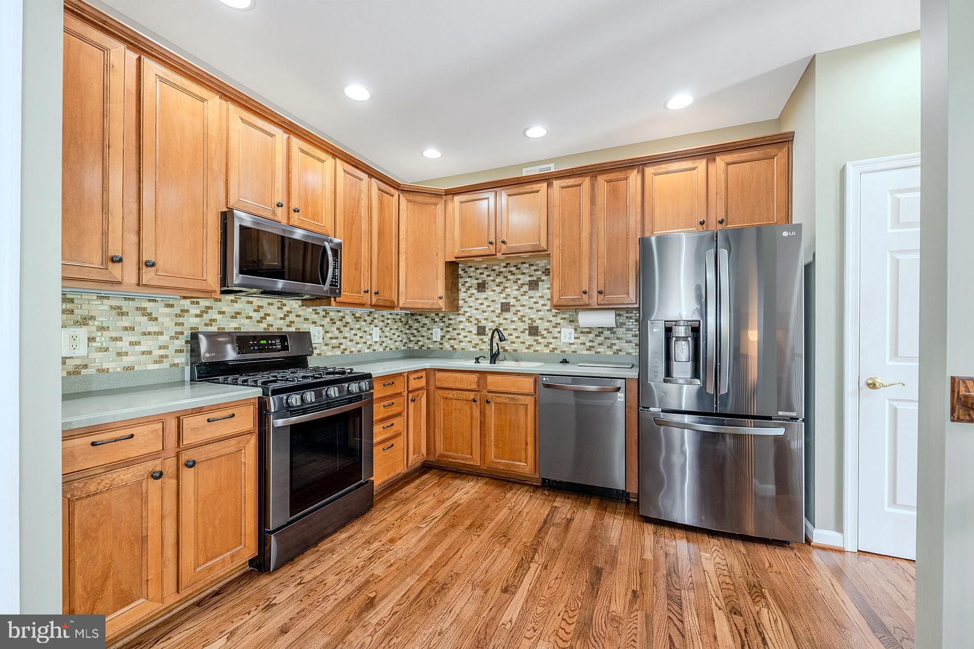 230 West Ridge Court Warrenton, VA 20186 - Photo 14 of 44 a kitchen with stainless steel appliances granite countertop a refrigerator a stove top oven a sink and cabinets