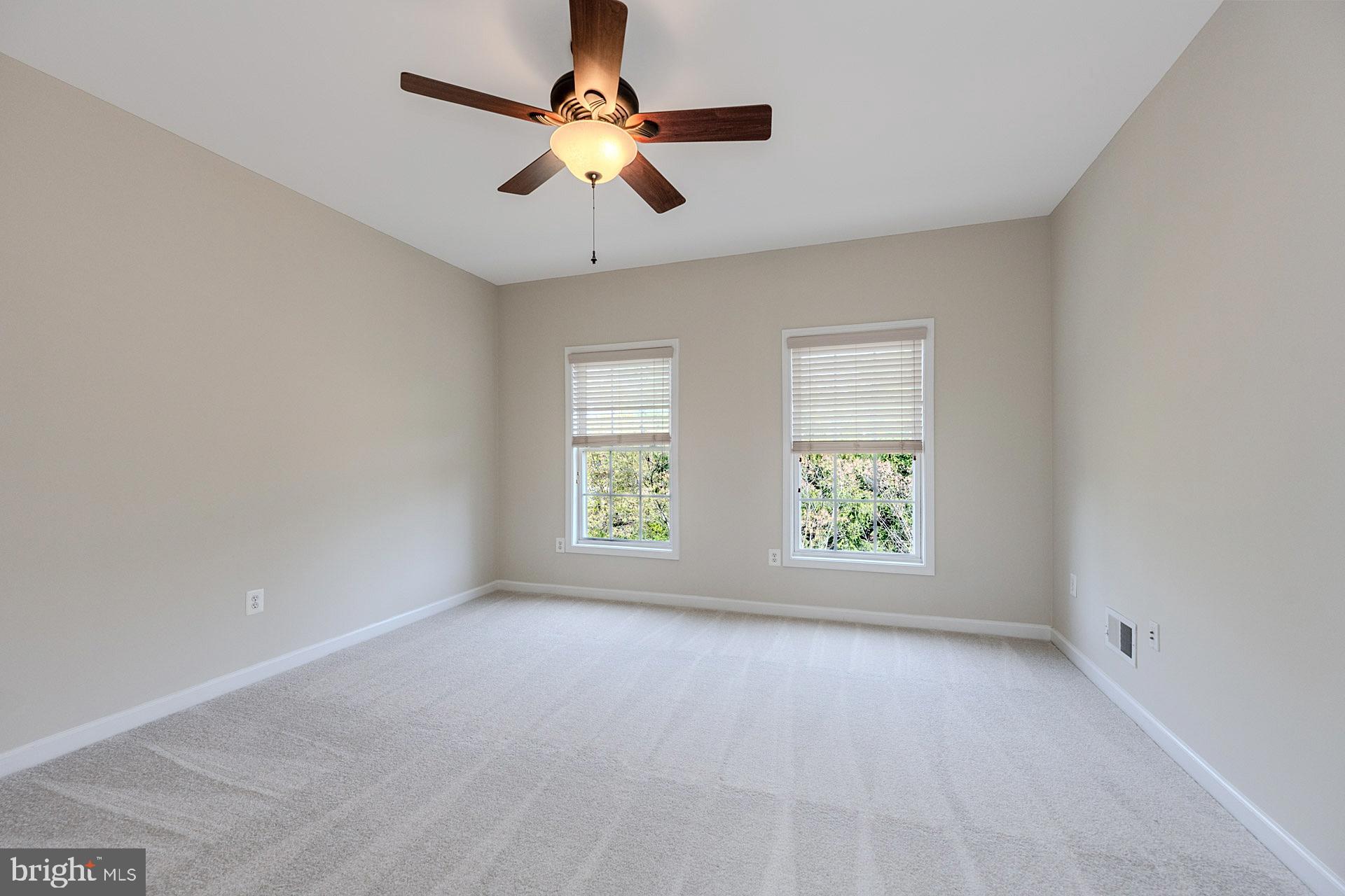 230 West Ridge Court Warrenton, VA 20186 - Photo 15 of 44 an empty room with windows and ceiling fan view