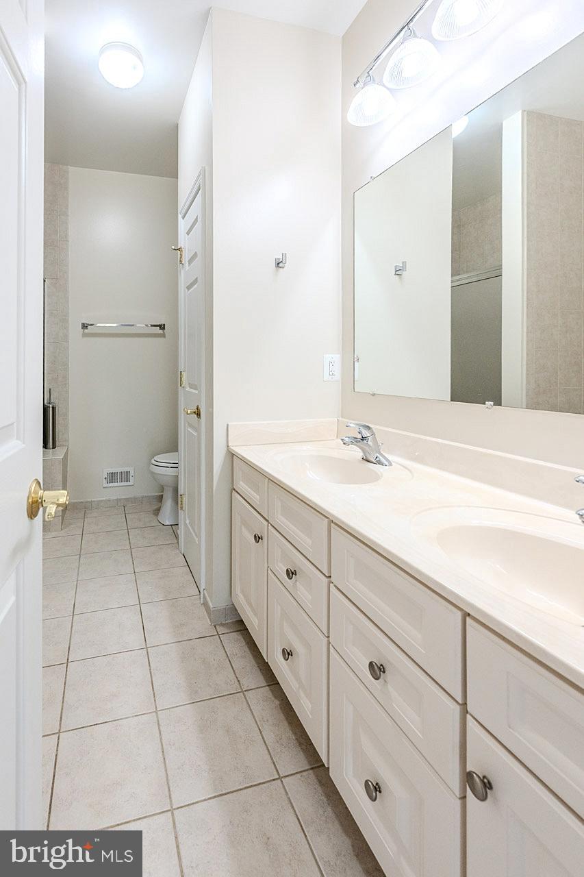 230 West Ridge Court Warrenton, VA 20186 - Photo 17 of 44 a spacious bathroom with a sink a toilet and a mirror
