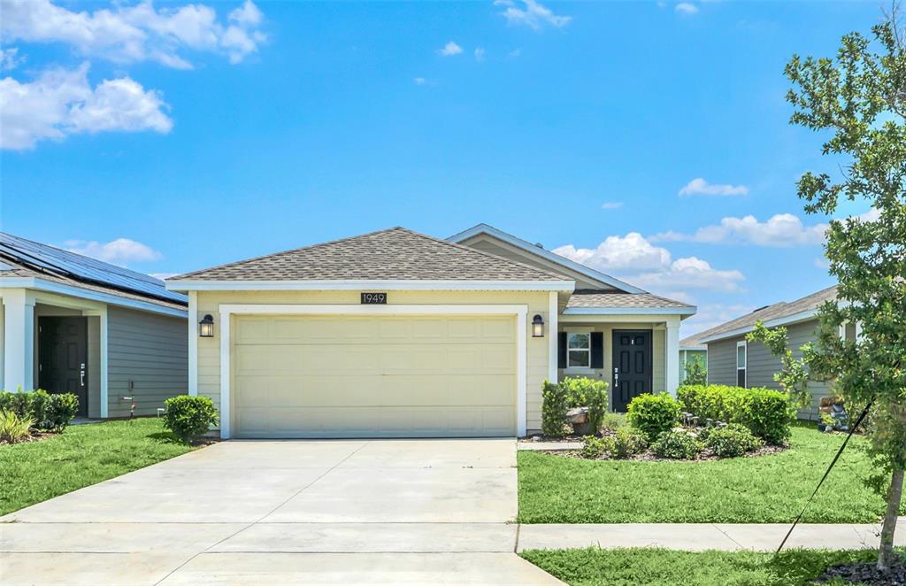 1949 Traverse Way Kissimmee, FL 34746 - Photo 1 of 1 a front view of a house with a yard and garage