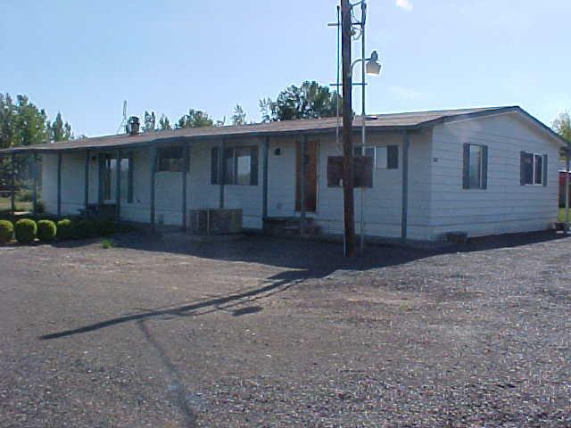 2990 Rosenkranz Road Tieton, WA 98947 - Photo 1 of 9 a front view of a house with a yard and garage