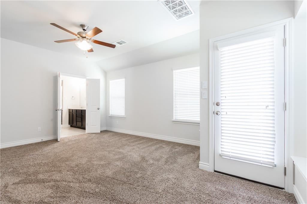 2104 Pindos Pony Way Georgetown, TX 78626 - Photo 13 of 30 Well-lit primary bedroom featuring a ceiling fan and convenient direct access to a private bath.