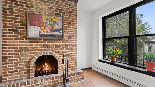 a living room with fireplace and window