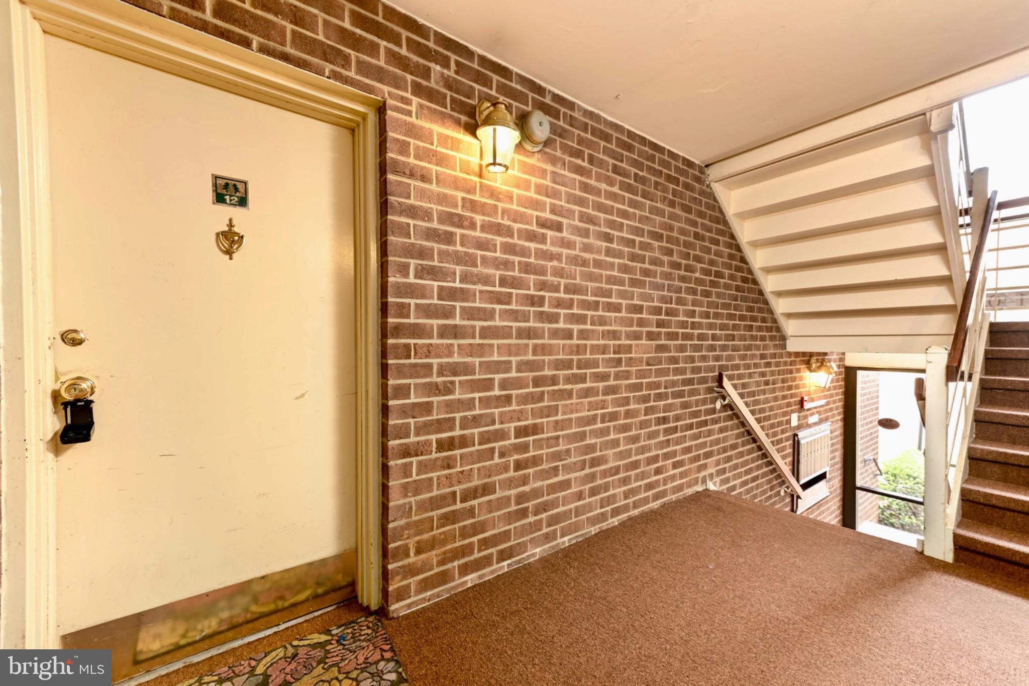 Inviting entrance with warm brick tones.