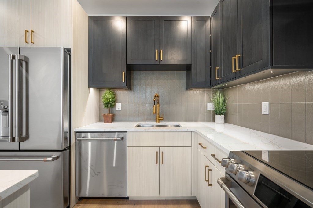 5245 Washington Street, Unit 6 Boston, MA 02132 - Photo 1 of 22 a kitchen with a sink a stove and cabinets