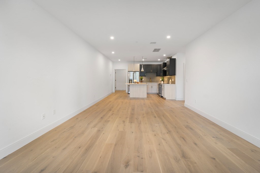 5245 Washington Street, Unit 6 Boston, MA 02132 - Photo 12 of 22 a view of a kitchen with wooden floor and a sink