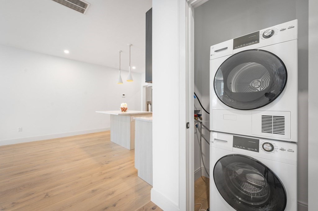5245 Washington Street, Unit 6 Boston, MA 02132 - Photo 13 of 22 a view of a hallway with washer and dryer