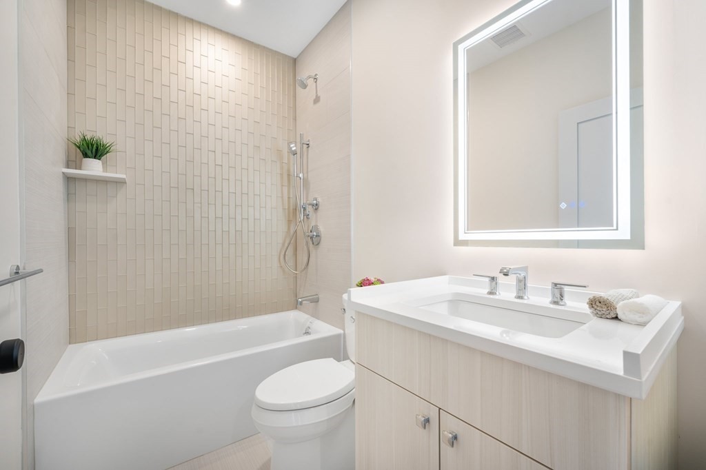5245 Washington Street, Unit 6 Boston, MA 02132 - Photo 15 of 22 a bathroom with a sink a toilet and shower