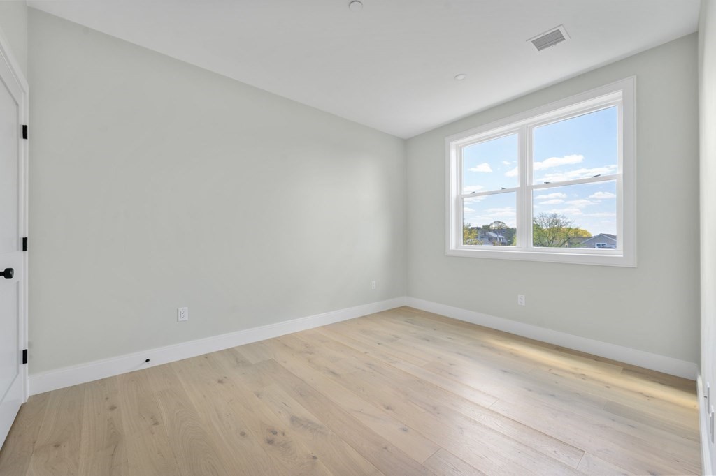 5245 Washington Street, Unit 6 Boston, MA 02132 - Photo 16 of 22 a view of an empty room with a window