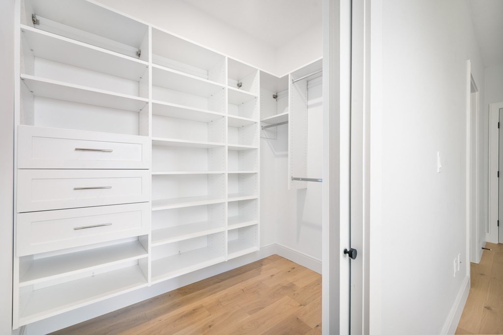 5245 Washington Street, Unit 6 Boston, MA 02132 - Photo 19 of 22 a view of walk in closet with empty racks