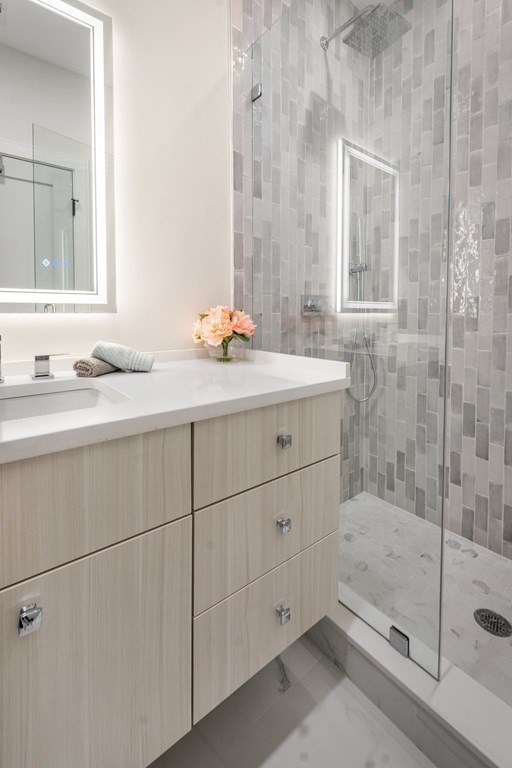 5245 Washington Street, Unit 6 Boston, MA 02132 - Photo 21 of 22 a bathroom with a sink and a mirror