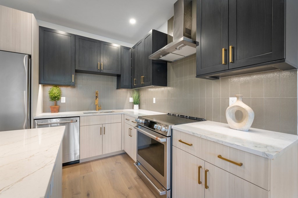 5245 Washington Street, Unit 6 Boston, MA 02132 - Photo 7 of 22 a kitchen with a stove and a sink