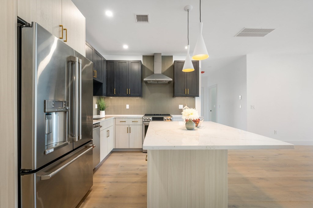 5245 Washington Street, Unit 6 Boston, MA 02132 - Photo 10 of 22 a kitchen with a sink stainless steel appliances and white cabinets
