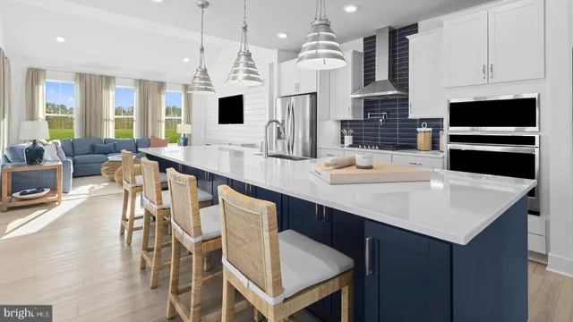 a kitchen with stainless steel appliances a kitchen island hardwood floor sink stove dining table and chairs