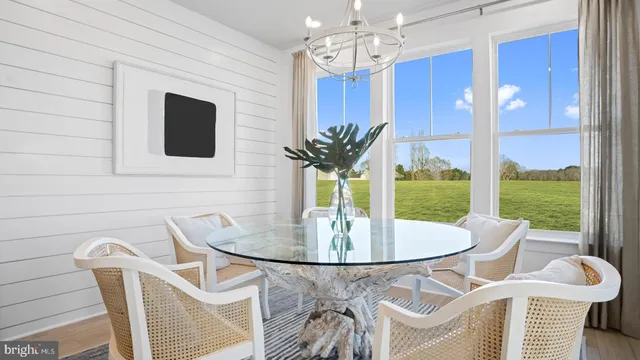 a dining room with furniture a floor to ceiling window and a fireplace