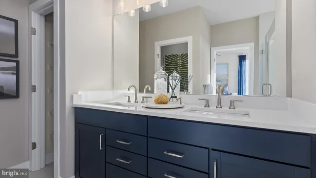 a bathroom with double sink and a mirror
