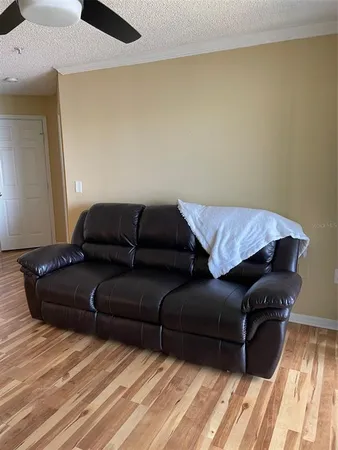 a living room with a couch and a wooden floor