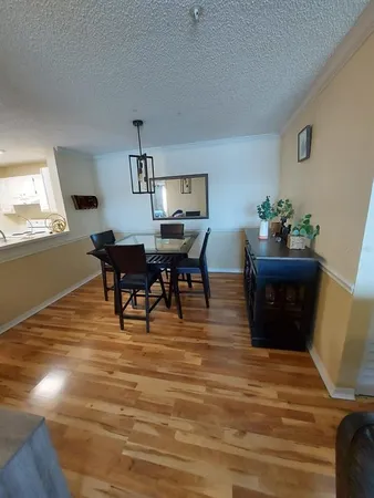 a living room with furniture and paintings on the wall