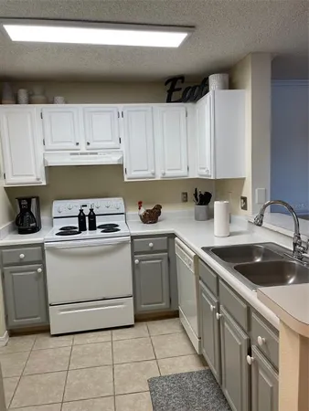 a kitchen with a sink dishwasher a stove and a microwave oven