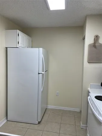 a view of a kitchen with a sink refrigerator and cabinet