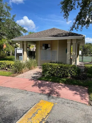 a front view of a house with a garden and plants