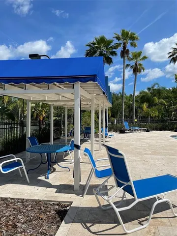 a view of a house with backyard sitting area and porch