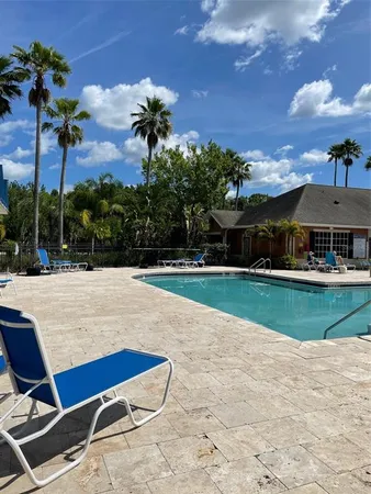 a swimming pool with outdoor seating and garden