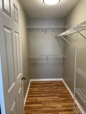 a view of a room with wooden floor