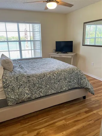 a bedroom with a bed and a large window