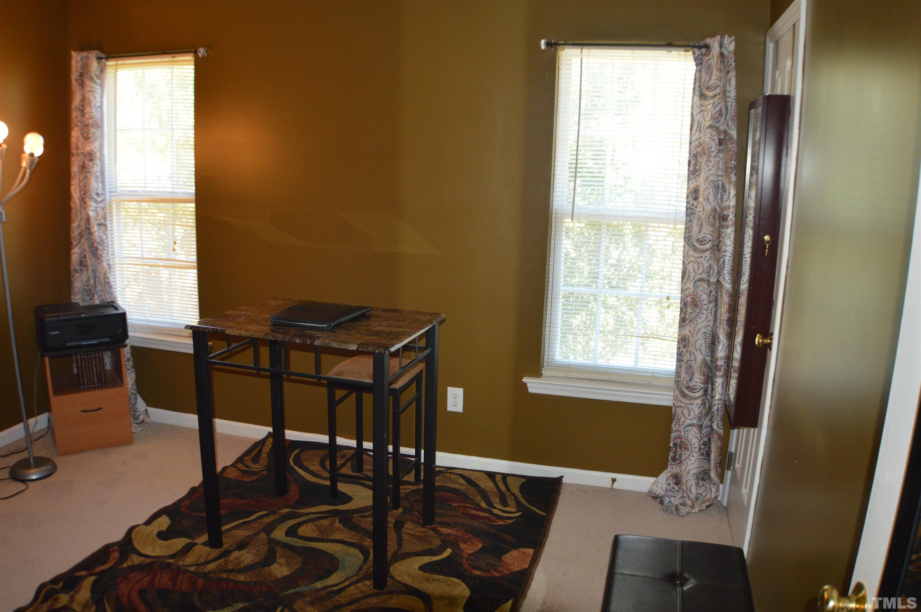 6523 Caverstone Lane Durham, NC 27713 - Photo 11 of 29 a view of a workspace with furniture and a window