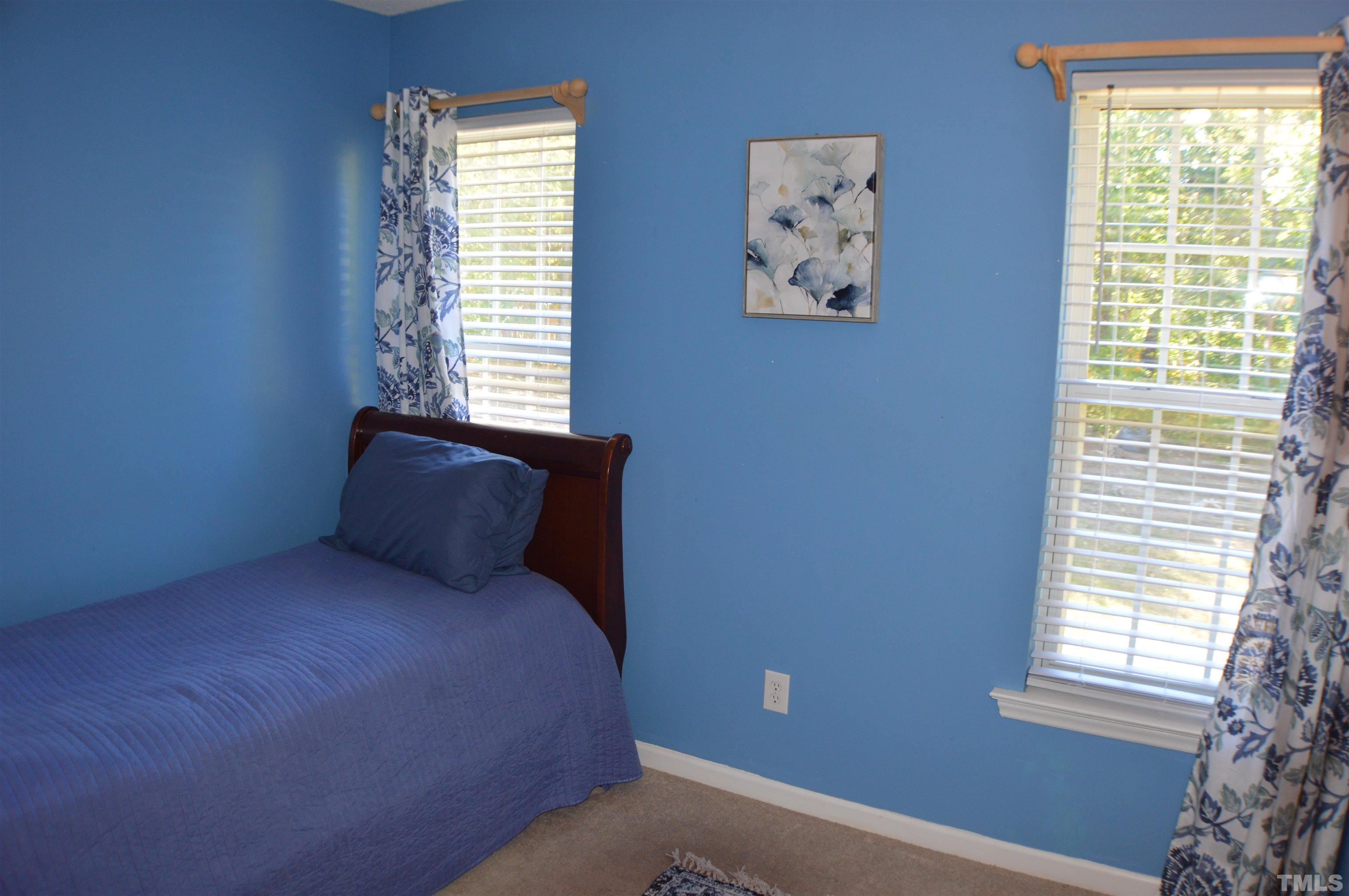 6523 Caverstone Lane Durham, NC 27713 - Photo 14 of 29 a bed sitting in a bedroom next to a window