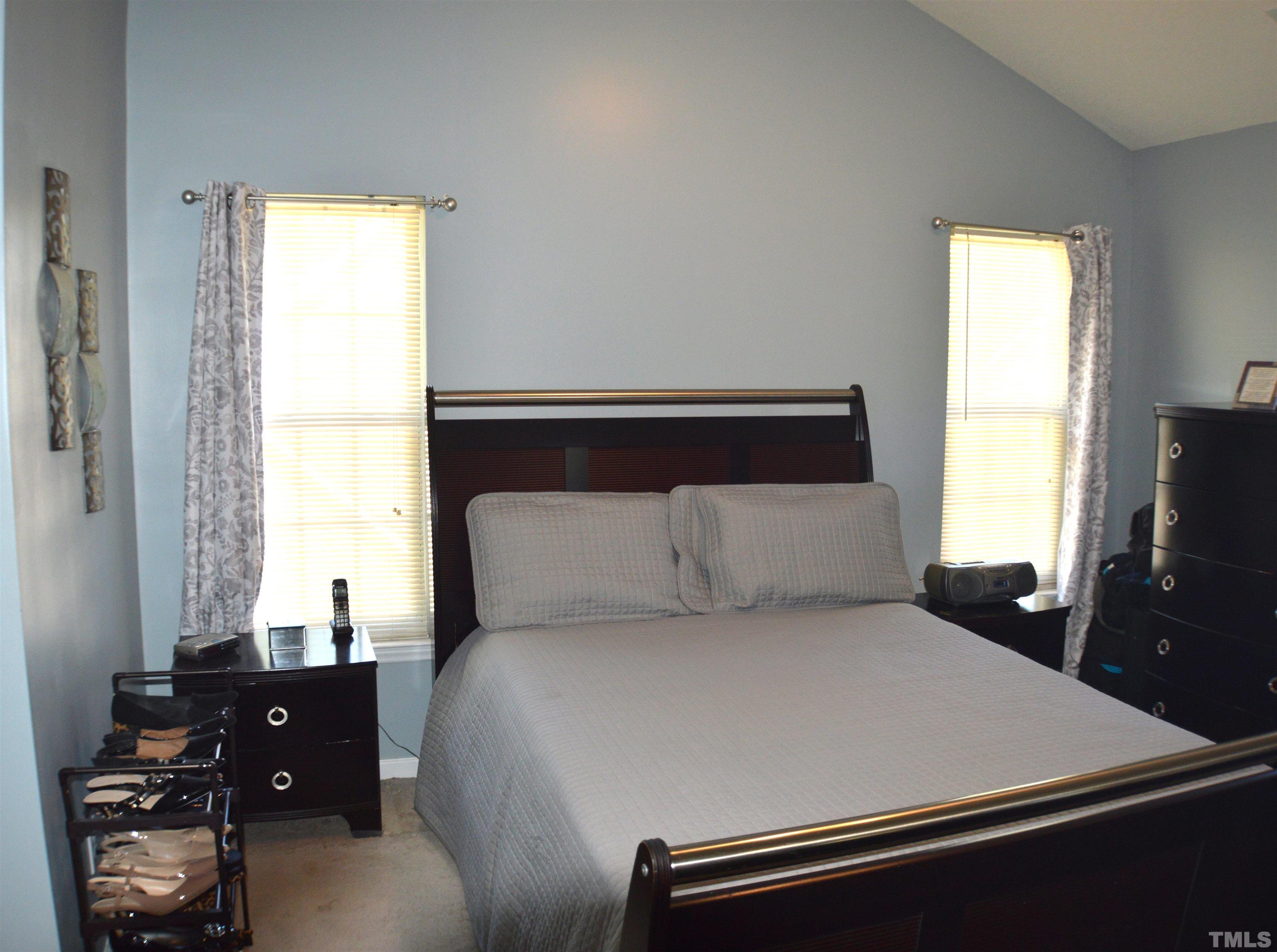 6523 Caverstone Lane Durham, NC 27713 - Photo 18 of 29 a large bed sitting in a bedroom next to a window