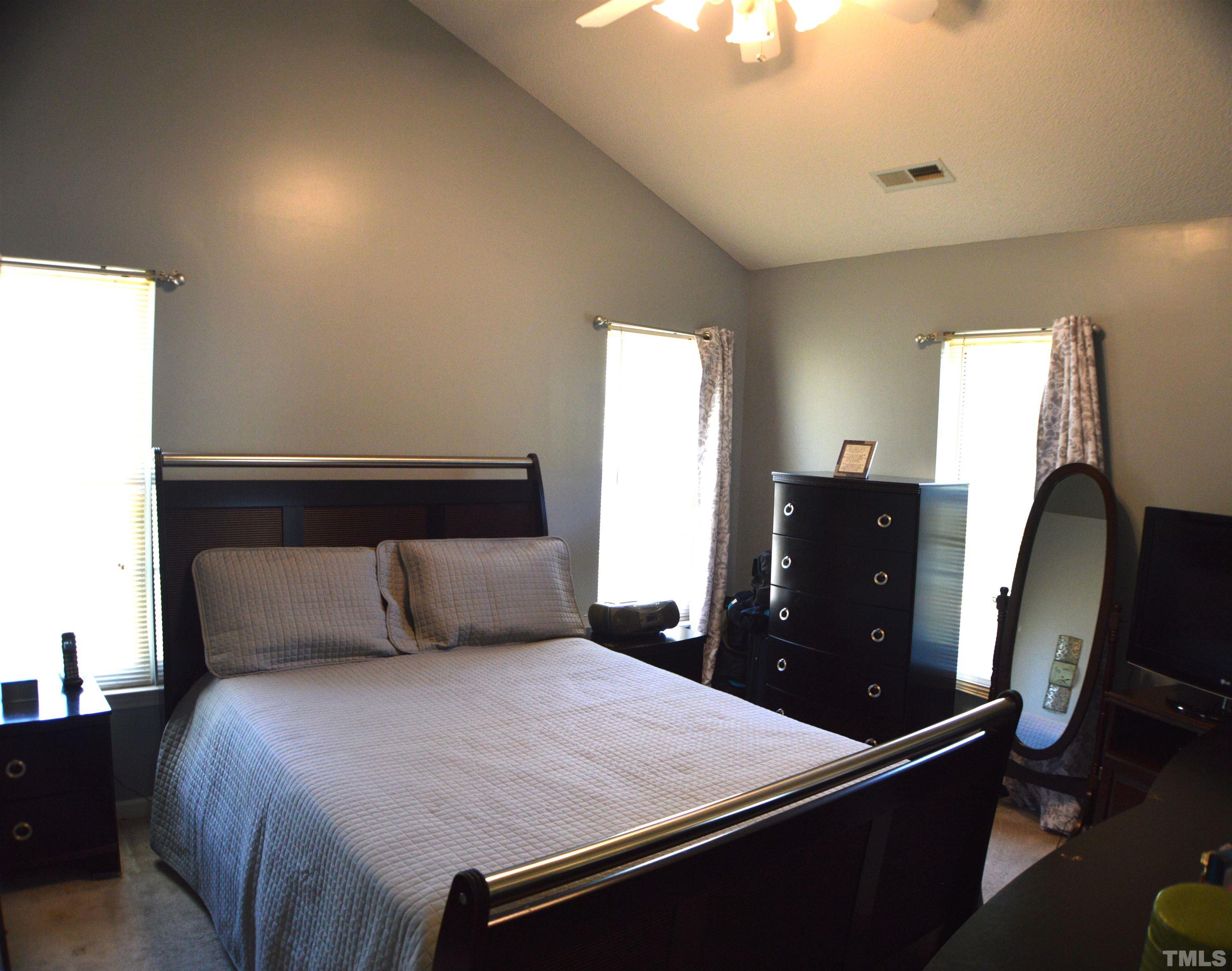 6523 Caverstone Lane Durham, NC 27713 - Photo 20 of 29 a bedroom with a bed and wooden floor