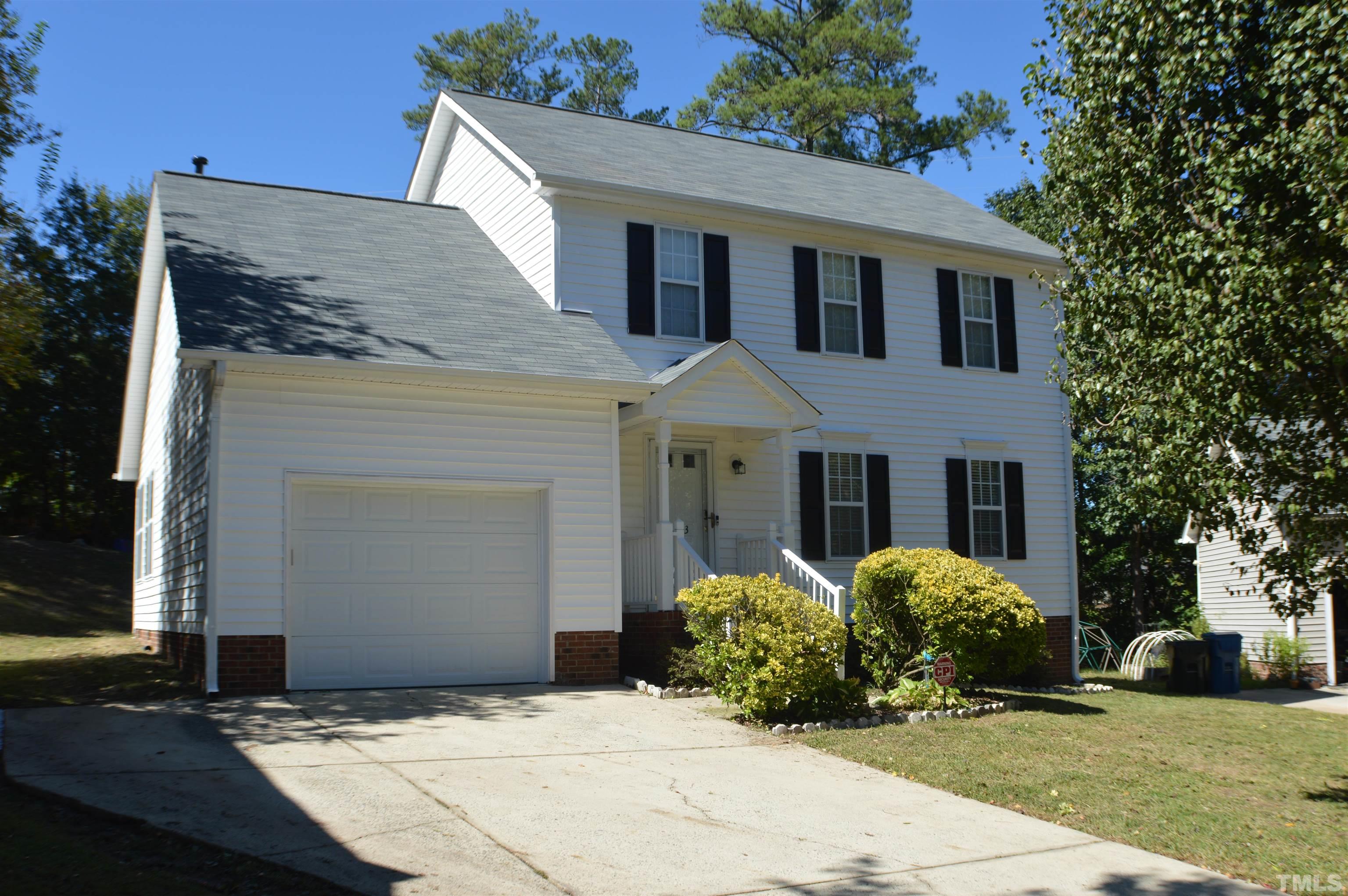 6523 Caverstone Lane Durham, NC 27713 - Photo 2 of 29 a front view of a house with a garden
