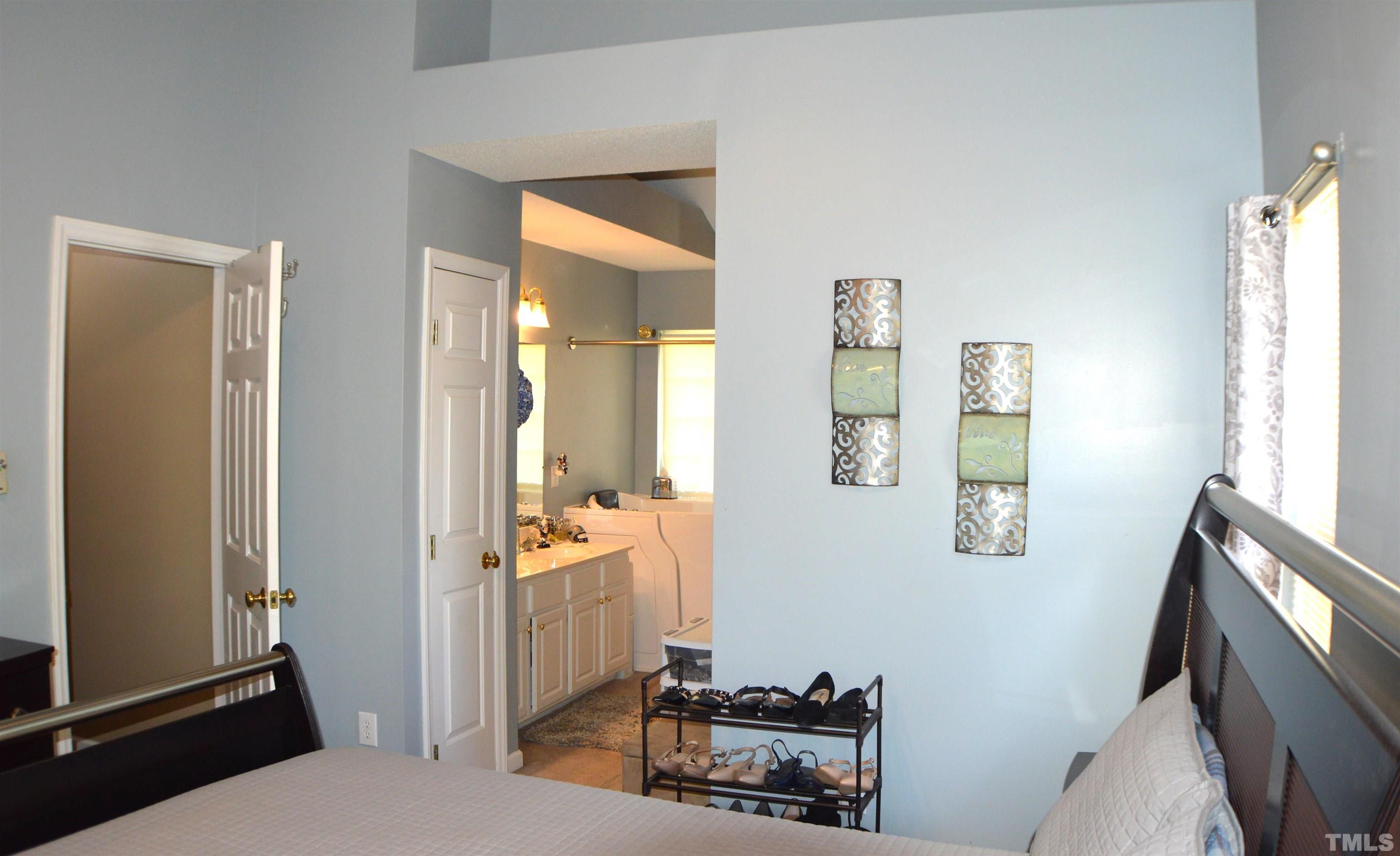 6523 Caverstone Lane Durham, NC 27713 - Photo 22 of 29 a bedroom with a bed and wooden floor