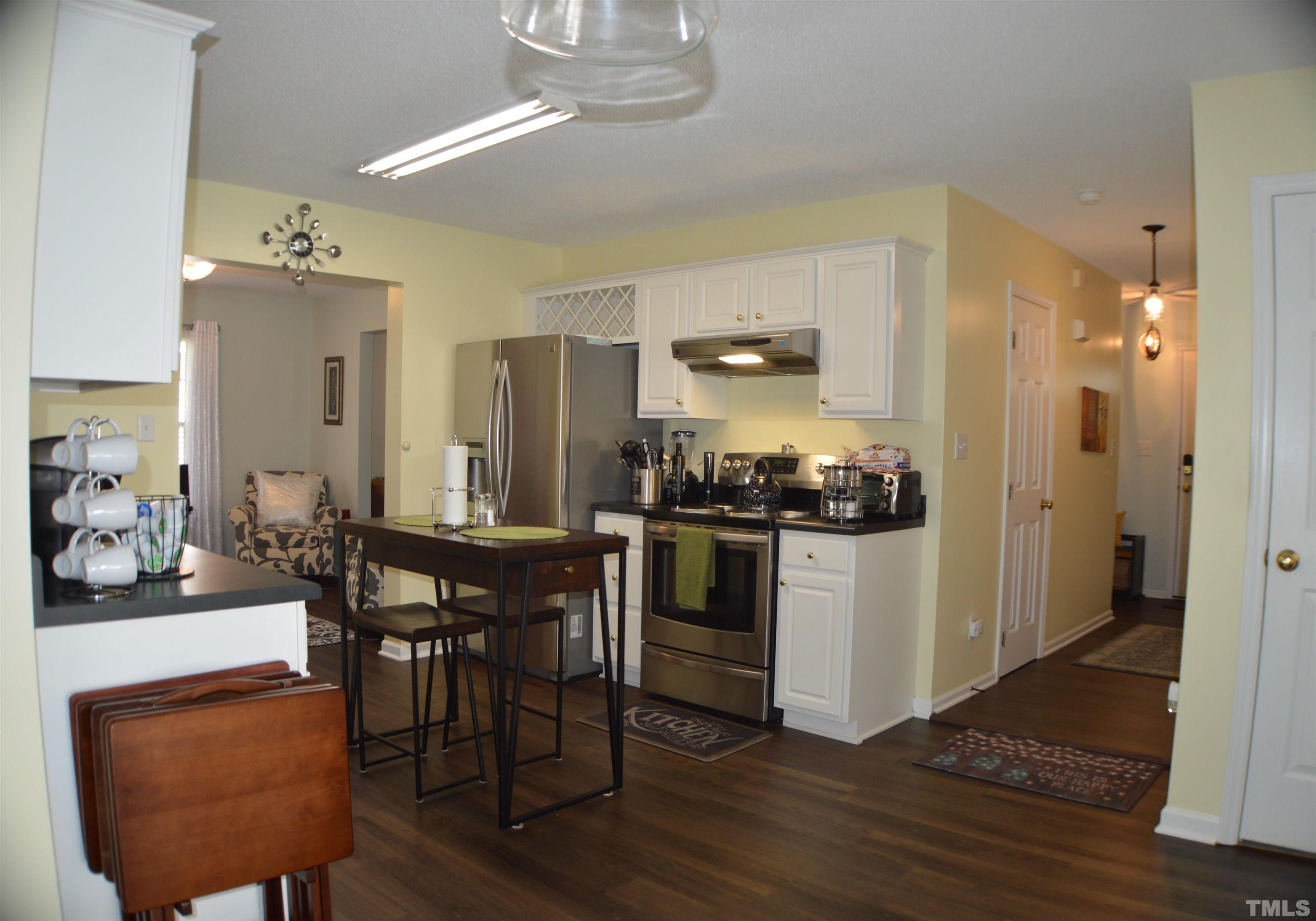 6523 Caverstone Lane Durham, NC 27713 - Photo 7 of 29 a kitchen with a table and chairs in it