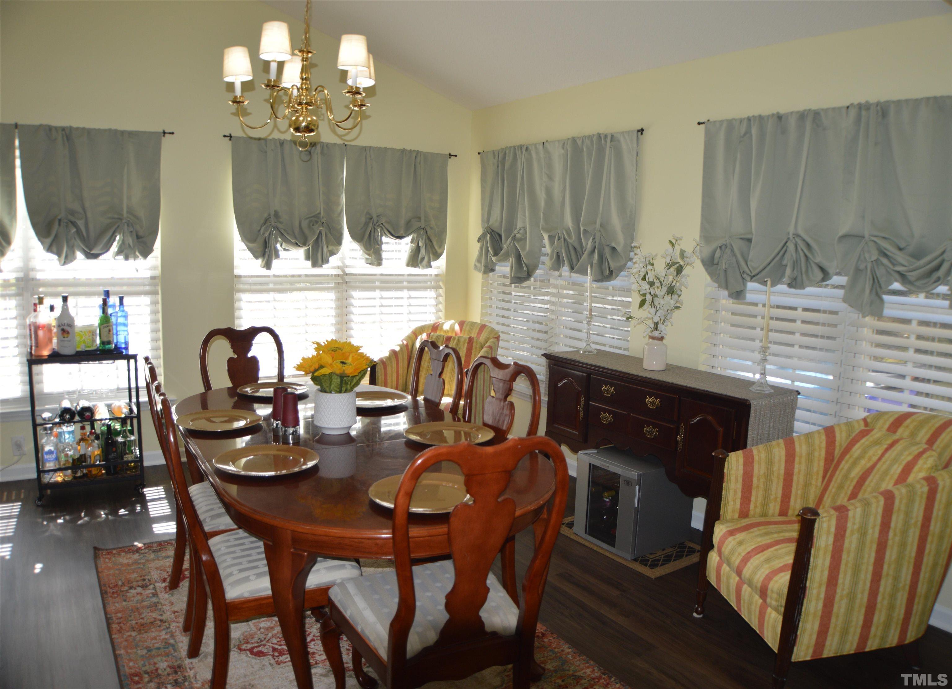 6523 Caverstone Lane Durham, NC 27713 - Photo 9 of 29 a view of a dining room with furniture and chandelier