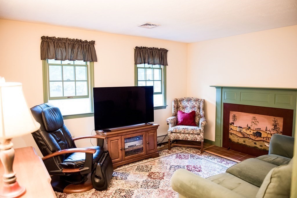39 George Brown Street Billerica, MA 01821 - Photo 8 of 29 a living room with furniture and a flat screen tv