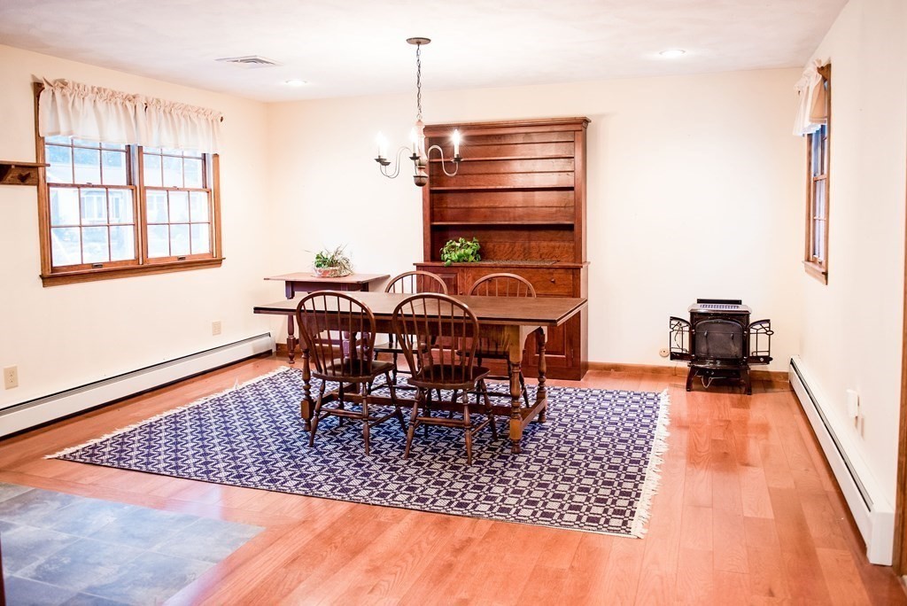 39 George Brown Street Billerica, MA 01821 - Photo 9 of 29 a dining room with a table chairs and a open kitchen view