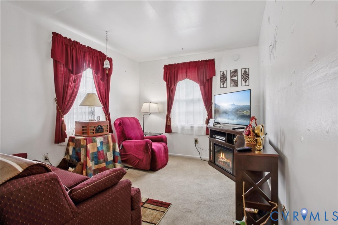 6266 Richmond Road Williamsburg, VA 23188 - Photo 15 of 27 a living room with furniture a flat screen tv and a window