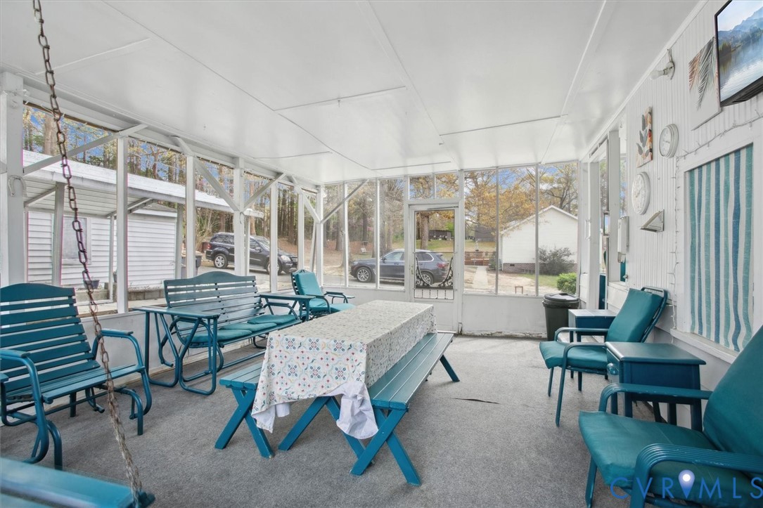 6266 Richmond Road Williamsburg, VA 23188 - Photo 21 of 27 a dining room with furniture and wooden floor